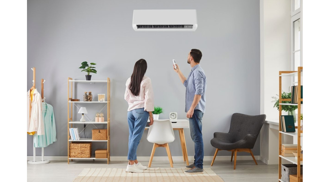 Couple turning on split air conditioning