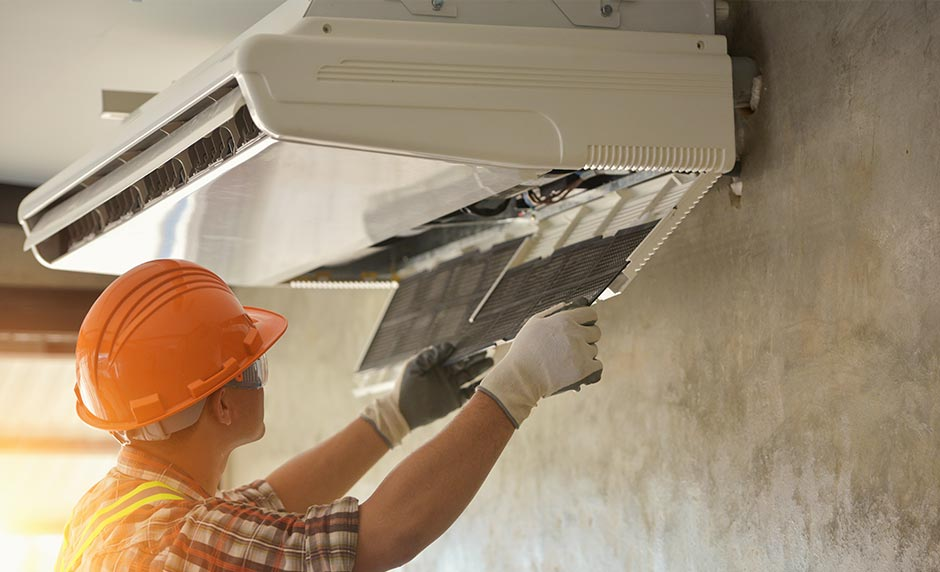 Technician opening split system for cleaning filter and foil