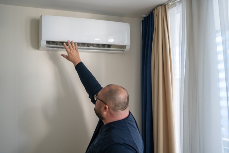 Man is checking split system AC cooling