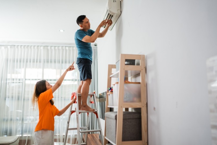 technician fixing split system cooling