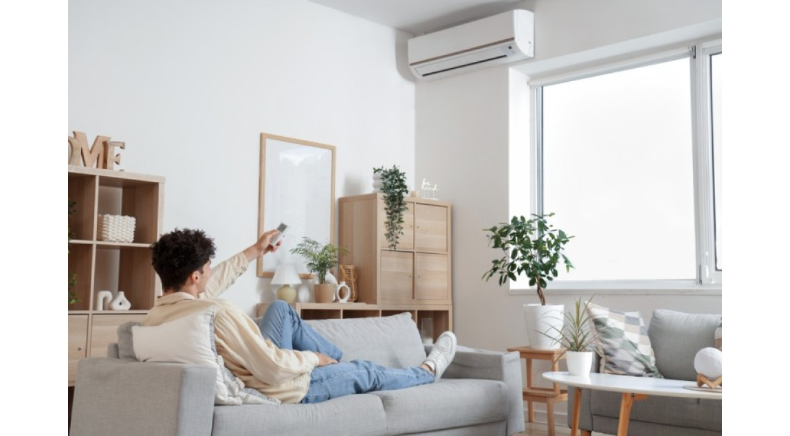 Man turning on Air Conditioner